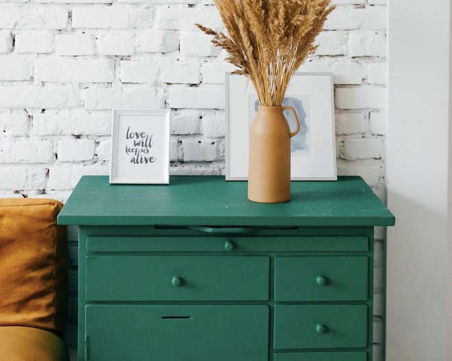drawers with books and a flower vase